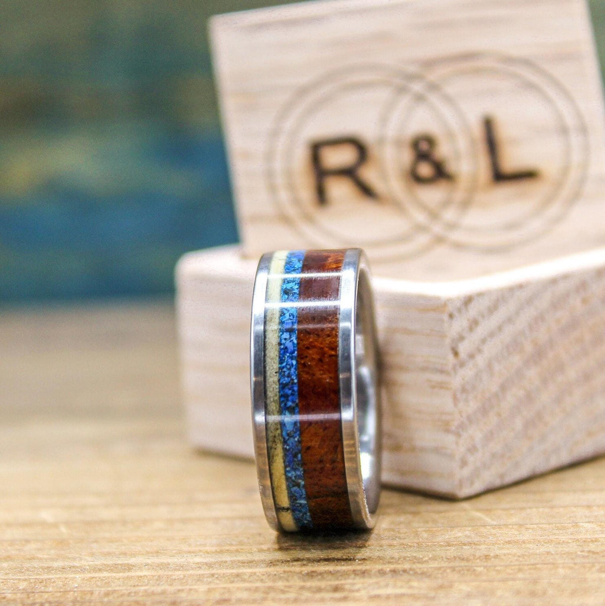 Titanium men's wedding band with Amboyna burl wood and turquoise inlay, featuring a 5.5mm band design.