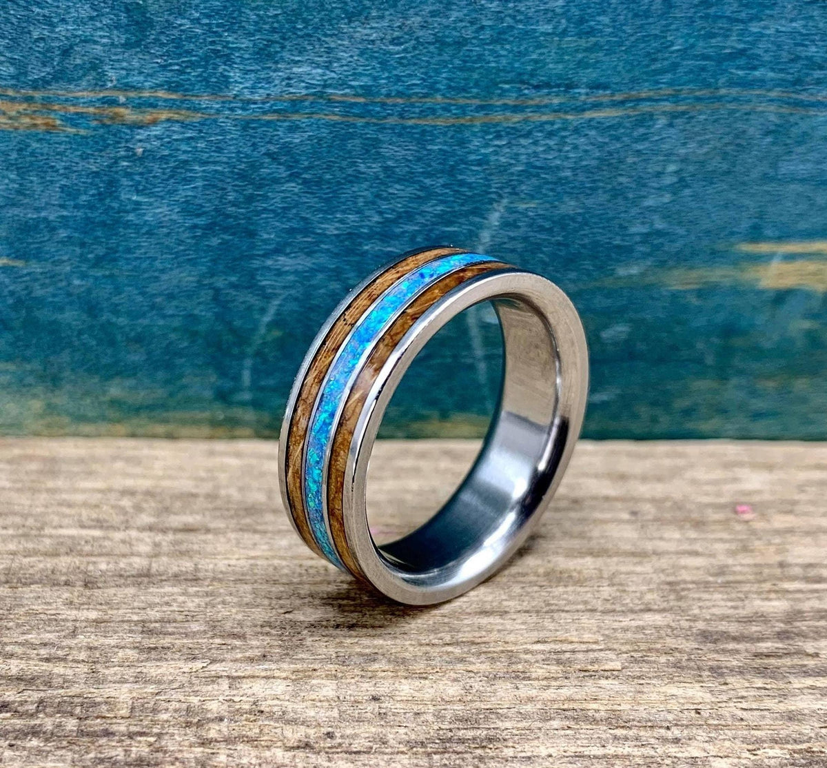 Titanium wedding band for men with whiskey barrel wood and opal inlay, engraved, by RobandLean's rings.