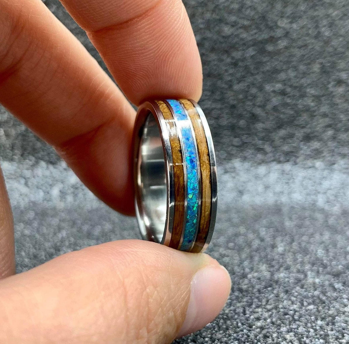 Titanium wedding band for him with whiskey barrel wood and opal, engraved design, from RobandLean's rings collection.