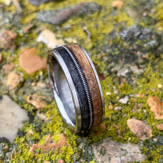 Titanium wedding band with guitar string inlay and whiskey barrel design from RobandLean's Rings, size 5.5mm, called The Gunslinger.