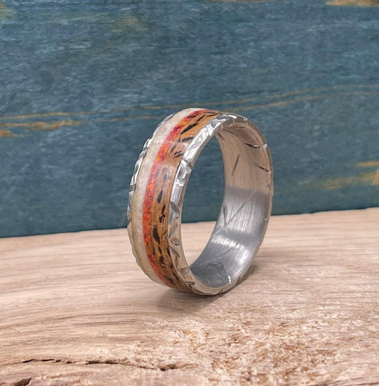 Men's titanium wedding band featuring deer antler design, red opal inlay, and whiskey barrel wood accents by RobandLean's rings