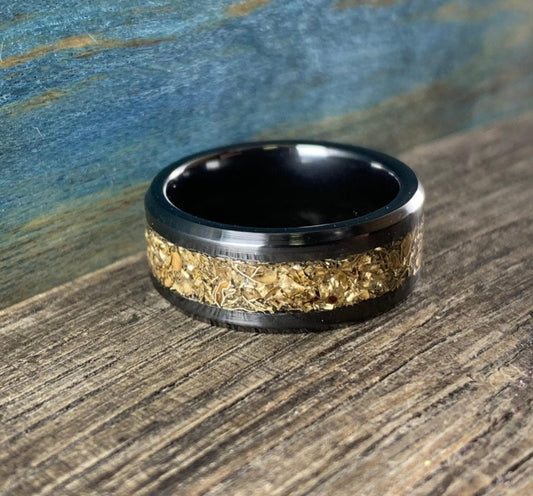 Black ceramic wedding band with recycled gold inlay, 8mm men's ring from RobandLean's rings, showcasing polished surface and craftsmanship.