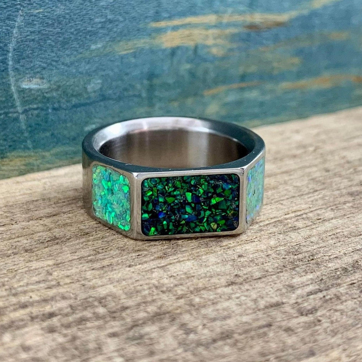 Men's green opal signet style titanium wedding band with a sleek design, crafted by RobandLean's rings.