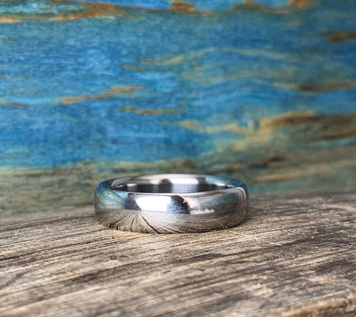 Polished titanium ring reflecting light with pristine mirror surface