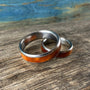 Matching his and hers titanium wedding rings with stabilized amboyna burl wood inlays