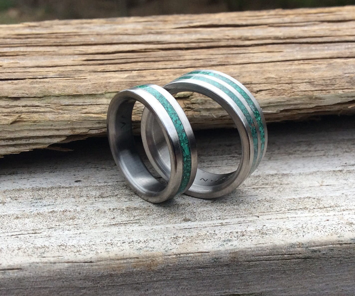His and hers matching titanium couples rings with malachite accents, featuring a sleek design for wedding bands.