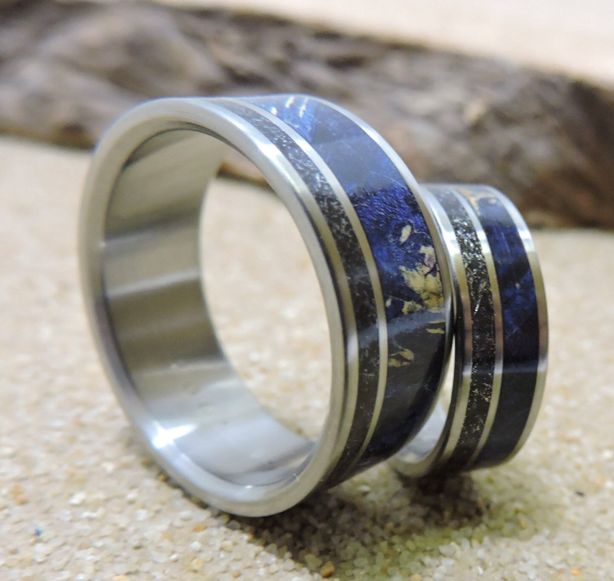 His and hers titanium wedding band set with meteorite and blue wood inlays, showcasing matching rings by RobandLean.