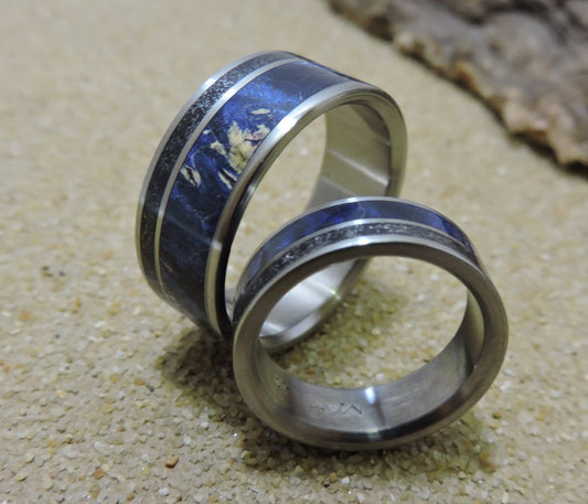 Pair of his and hers titanium wedding bands with meteorite and blue wood inlay, showcasing the matching design by RobandLean's rings.