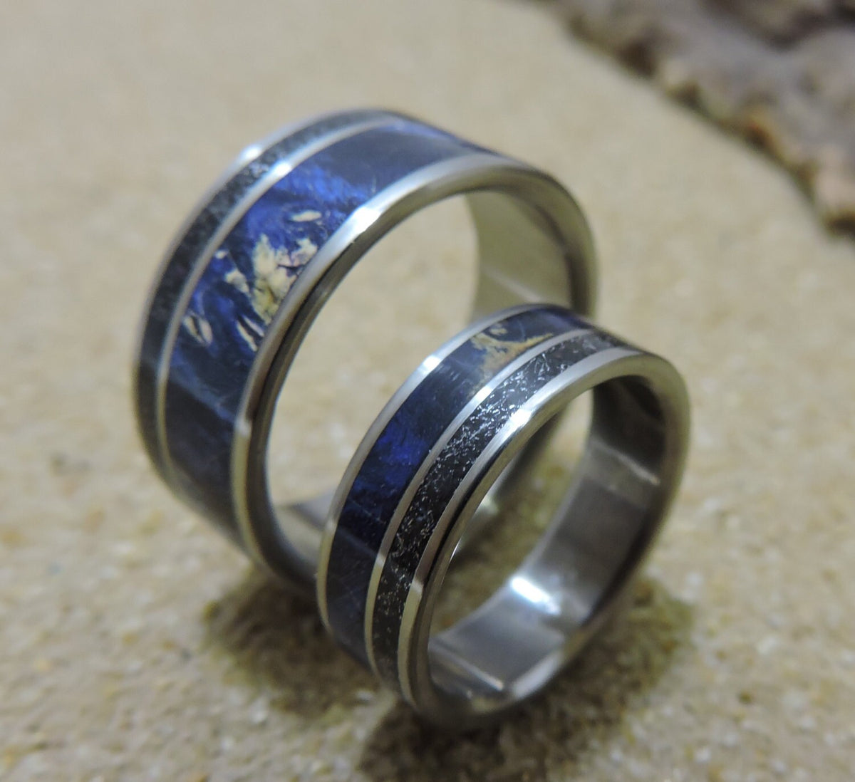 His and hers titanium wedding bands with meteorite and blue wood inlay, featuring sleek, modern design by RobandLean's rings.