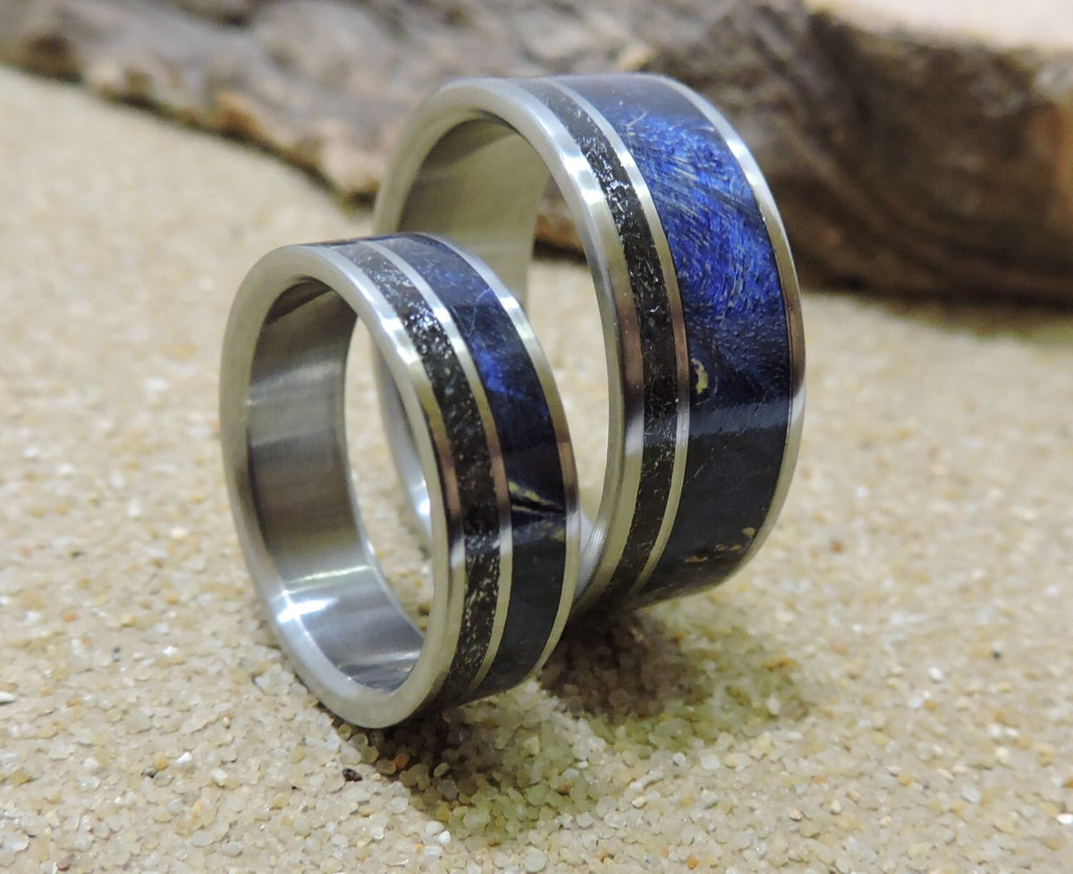 His and hers titanium wedding bands with meteorite and blue wood inlay, featuring sleek, matching design from RobandLean's rings.