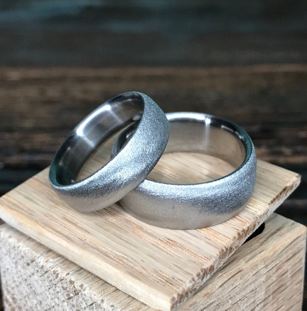 Luster finish titanium wedding band set by RobandLean's rings, featuring sleek, polished silver rings for couples.