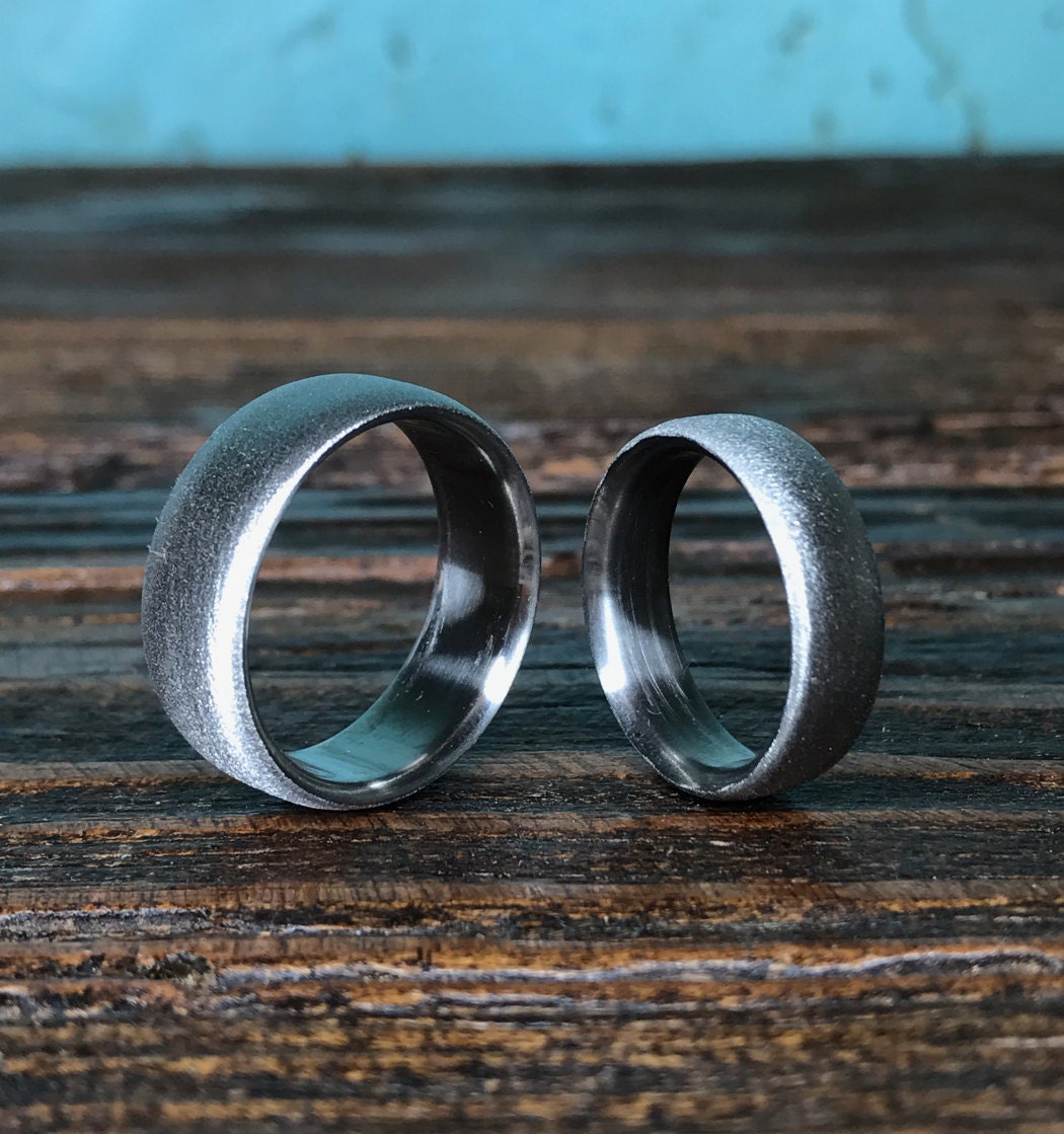 Luster finish titanium wedding band set by RobandLean's rings, featuring sleek, polished rings with a smooth, shiny surface.