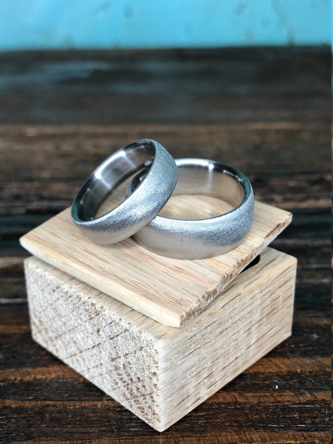 Luster finish titanium wedding band set by RobandLean's rings, featuring two sleek, polished silver rings for couples.
