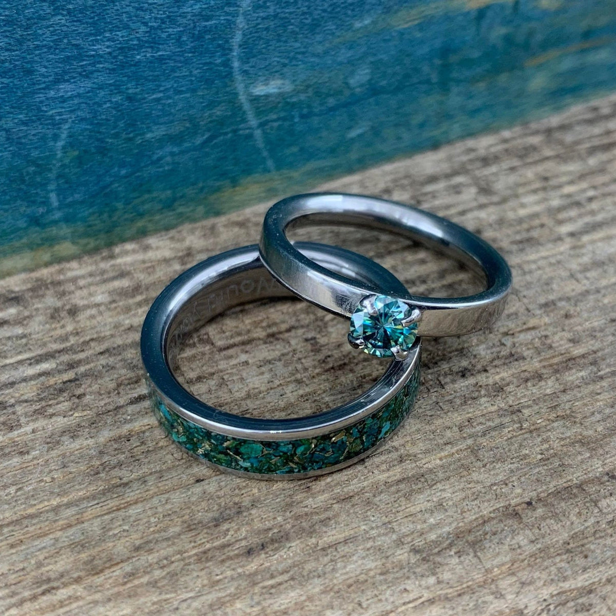 RobandLean's Hobgoblin Set featuring blue-green moissanite engagement rings with intricate detailing and sparkling gemstones.
