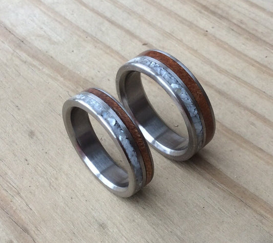Titanium ring by RobandLean with mother of pearl and ancient Kauri wood inlays, showcasing a sleek, polished design.