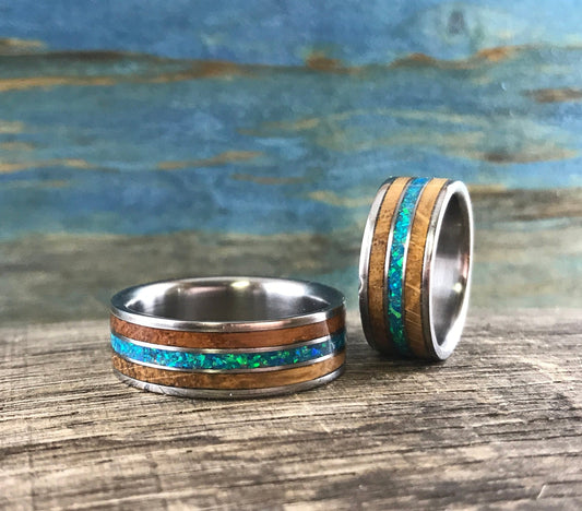 RobandLean's titanium ring featuring whiskey barrel wood inlay and blue-green opal, showcasing unique craftsmanship and vibrant colors.