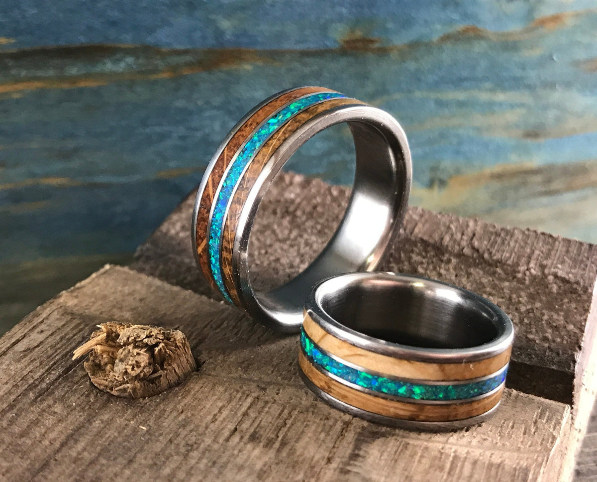 RobandLean's titanium ring featuring whiskey barrel wood inlay and blue-green opal, showcasing a unique, handcrafted design.