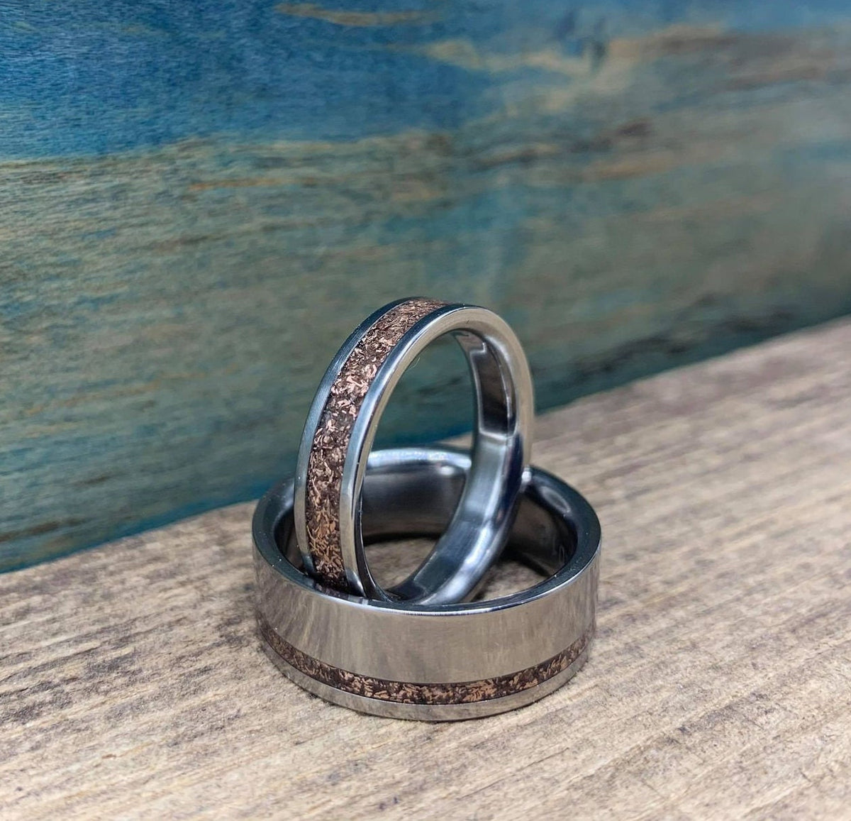 RobandLean's titanium rose gold wedding bands set for him and her, featuring sleek, matching elegant rings with a polished finish.