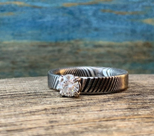 Ladies Moissanite Damascus Steel Engagement Ring with intricate pattern and sparkling stone from RobandLean's rings collection.