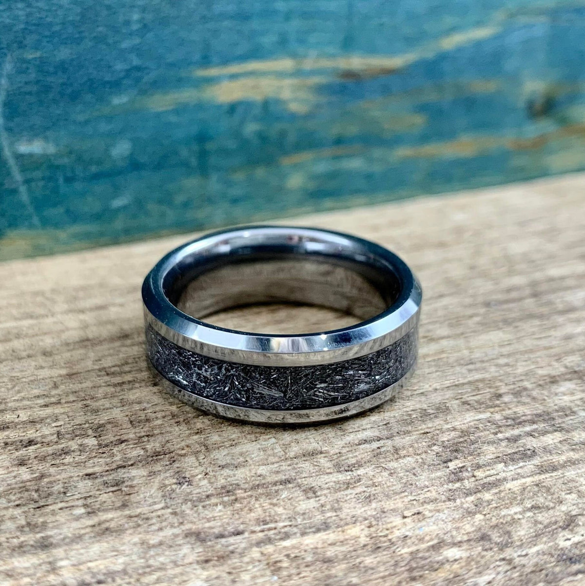 Custom-made tungsten and meteorite ring from RobandLean's rings, showcasing a unique blend of metal and meteorite in a detailed close-up.