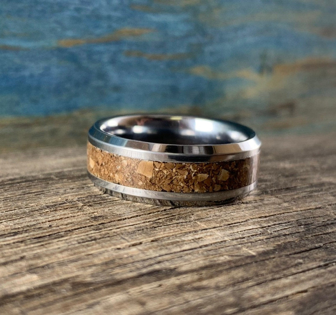 Men's tungsten dinosaur bone ring with T-Rex bone inlay, featuring a sleek wedding band design by RobandLean's rings.