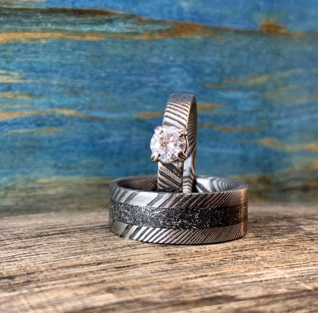 Damascus steel wedding band set with meteorite accents and moissanite stones, matching rings by RobandLean's rings.
