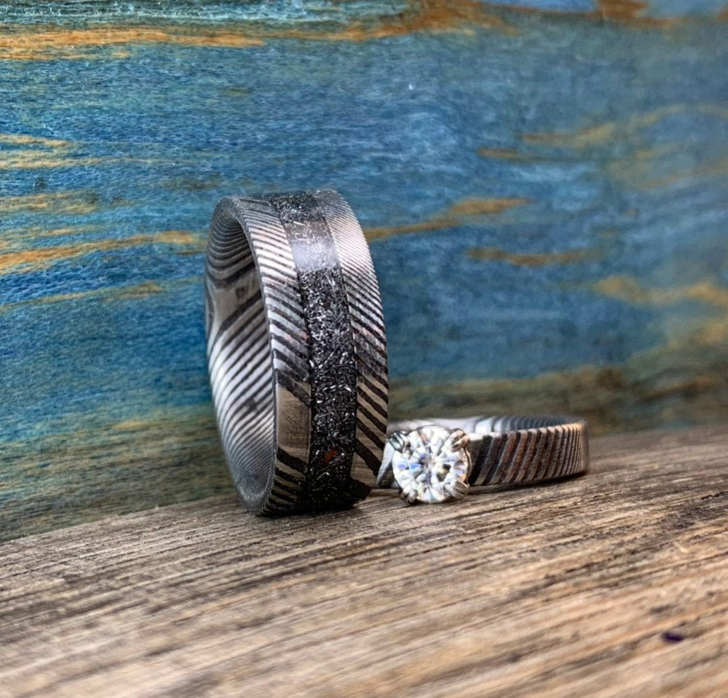 Damascus steel, meteorite, and moissanite wedding band set by RobandLean's rings, featuring matching rings with unique textures and gemstones.