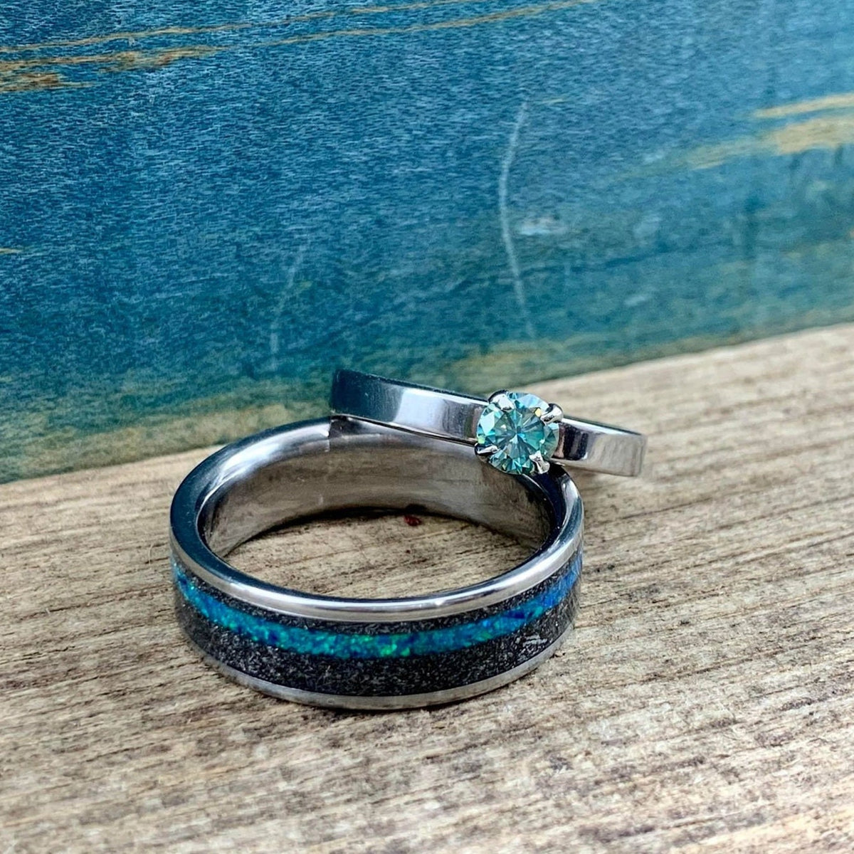 His and hers meteorite wedding bands with moissanite engagement ring by RobandLean's rings, featuring sleek metallic finishes and sparkling stones.